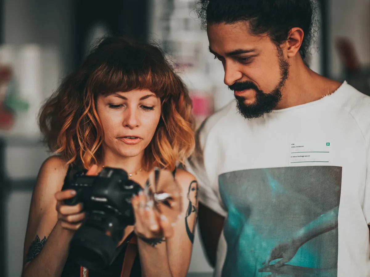Un photographe professionnel qui manie son boîtier lors d'un reportage en entreprise