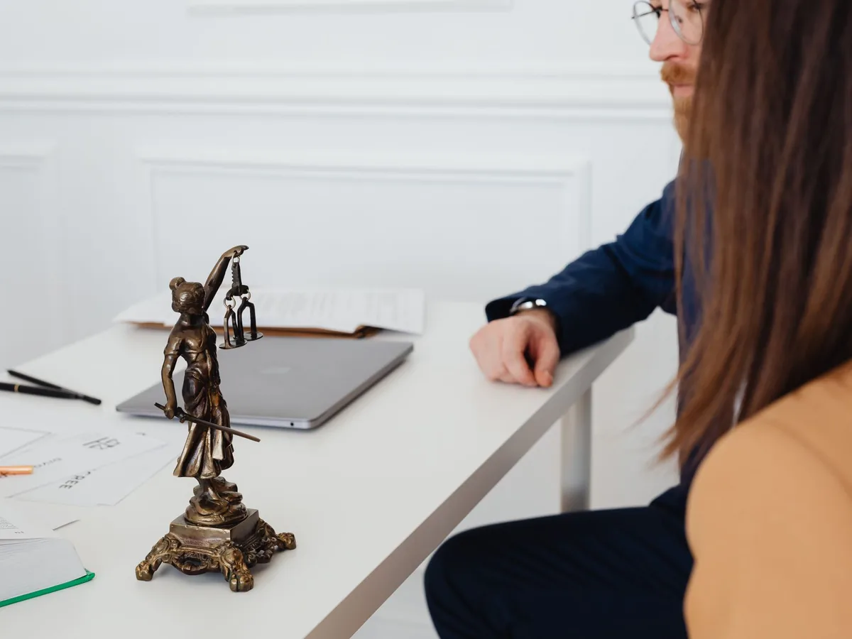 Un avocat consulte un détails de facture devant son ordinateur portable dans son cabinet.